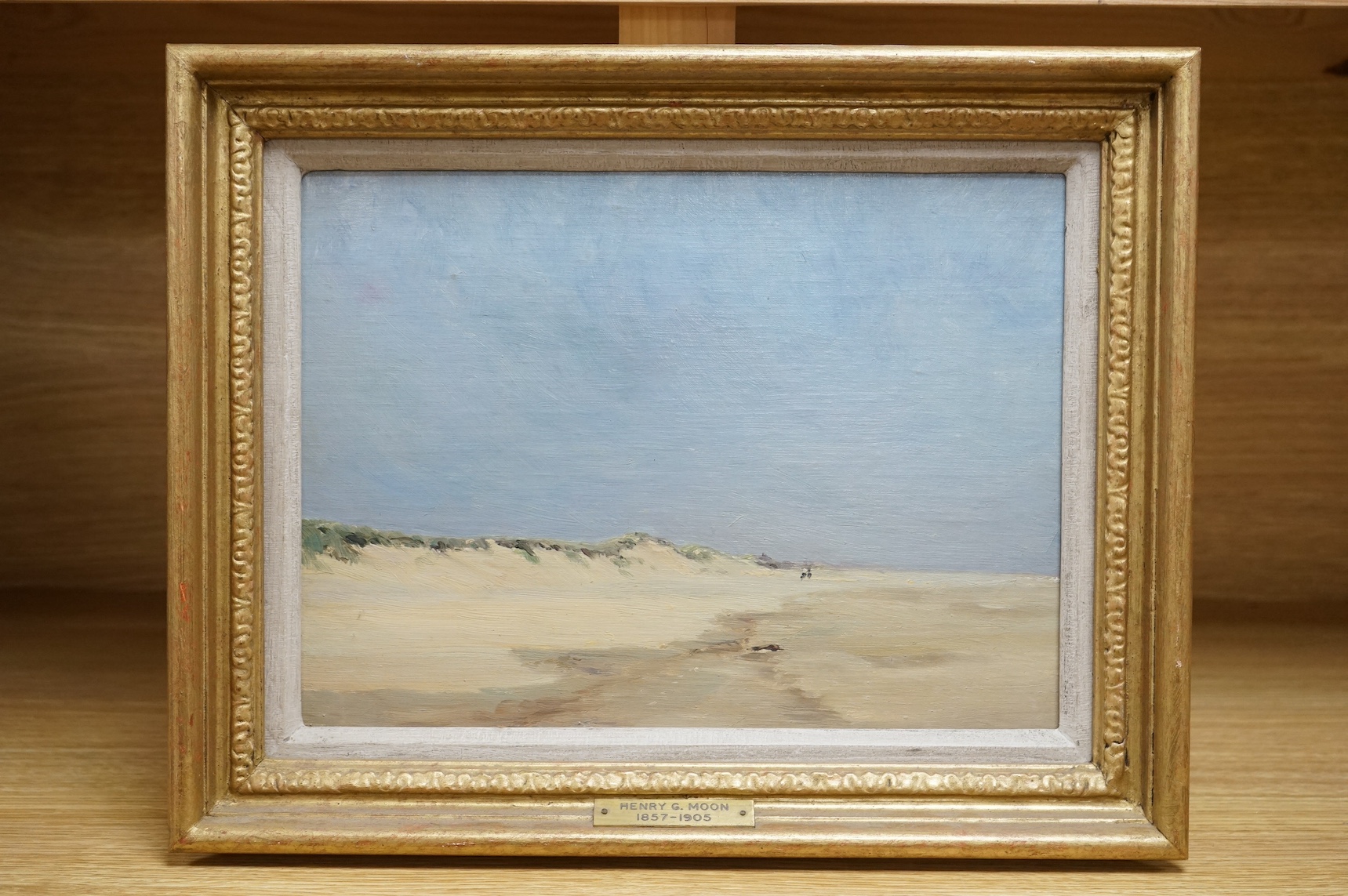 Henry G. Moon (1857-1905), oil on board, Coastal scene with figures, signed in ink verso, inscribed plaque, 21 x 29cm, gilt frame. Condition - good